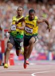 Jamaica's Michael Frater passes the baton to Yohan Blake