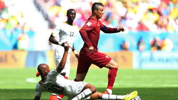2014 Fifa World Cup - Portugal's Cristiano Ronaldo is tackled by Ghana's Andre Ayew.