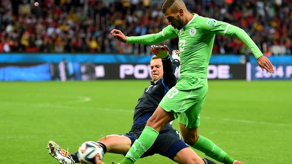 2014 FIFA World Cup - Algeria forward Islam Slimani is tackled by Germany goalkeeper Manuel Neuer.