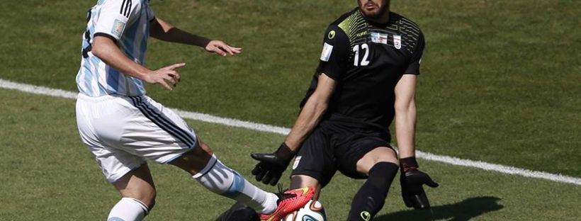 2014 Fifa World Cup - Argentina's Gonzalo Higuain fails to get the ball past Iran's goalkeeper Alireza Haqiqi