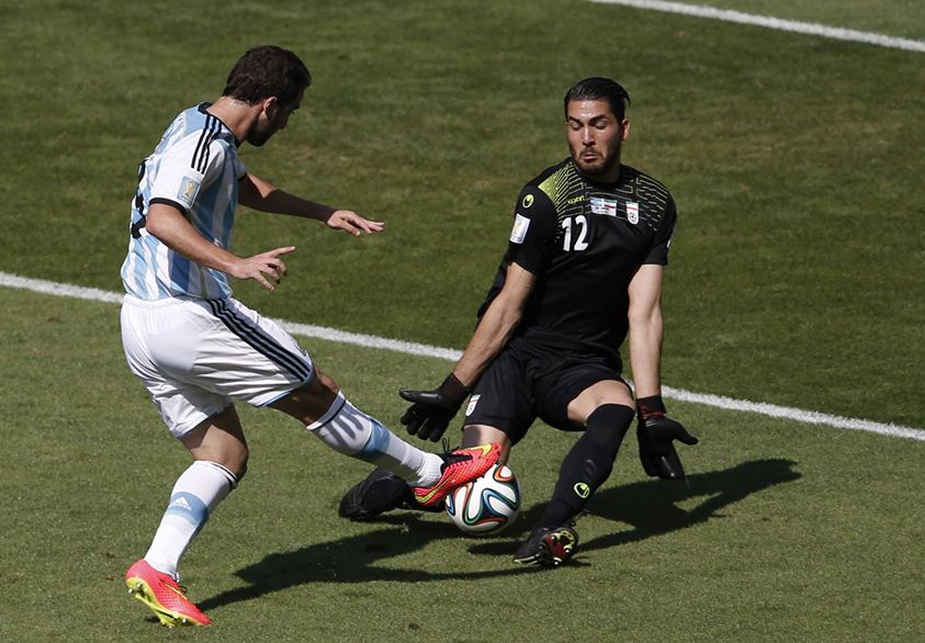 2014 Fifa World Cup - Argentina's Gonzalo Higuain fails to get the ball past Iran's goalkeeper Alireza Haqiqi