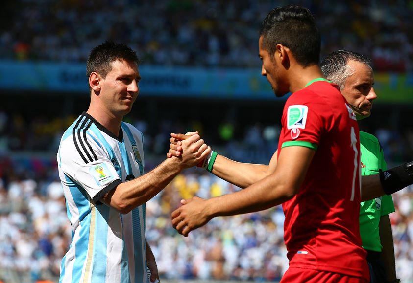 2014 Fifa World Cup -Argentina's Lionel Messi shakes hands with Reza Ghoochannejhad