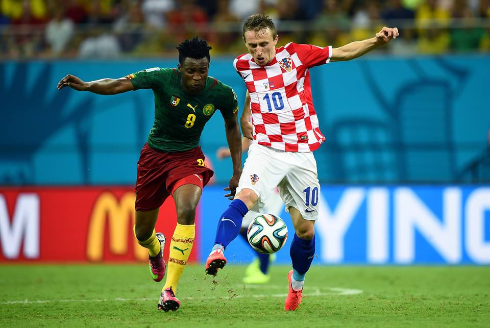 2014 FIFA World Cup - Cameroon midfielder Benjamin Moukandjo views for the ball with Croatia midfielder Luka Modric.