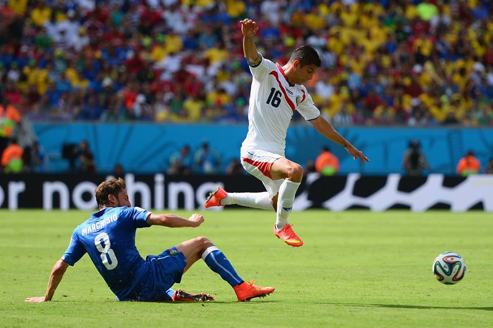 Costa Rica's Cristian Gamboa hops over Italy midfielder Claudio Marchisio. - Italy 0-1 Costa Rica