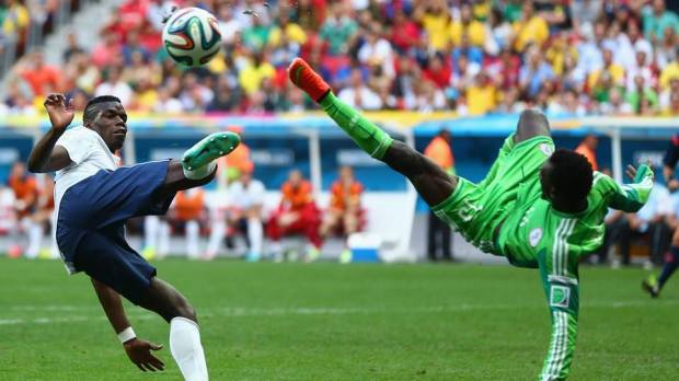 2014 FIFA World Cup - France's Pogba and Nigeria's Juwon Oshaniwa compete for the ball in acrobatic fashion.