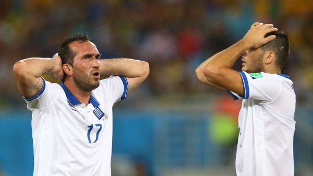 2014 FIFA World Cup - Greece's Theofanis Gekas and Konstantinos Manolas react after a missed chance in rainy Natal.