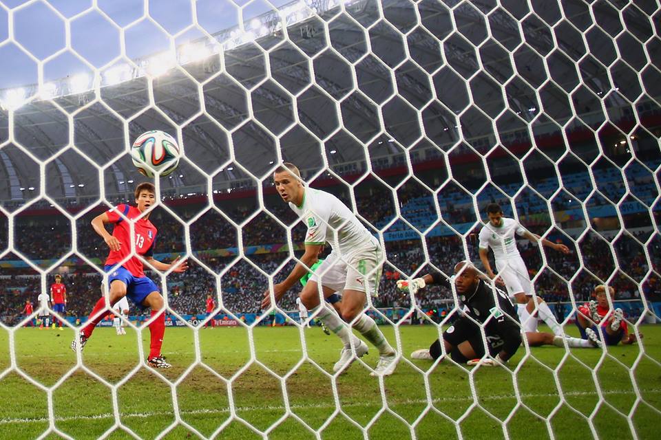 2014 FIFA World Cup - Koo Ja-Cheol of South Korea (L) scores his team's second goal past Djamel Mesbah and goalkeeper Rais M'Bolhi of Algeria