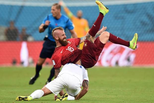 2014 FIFA World Cup - Kyle Beckerman of the United States tackles Raul Meireles of Portugal during the 2014 FIFA World Cup Brazil