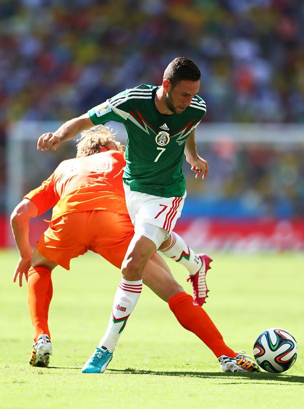 2014 FIFA World Cup - Netherlands' Dirk Kuyt challenges Miguel Layun of Mexico.