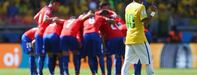 2014 FIFA World Cup - Neymar prays while Chile huddle.
