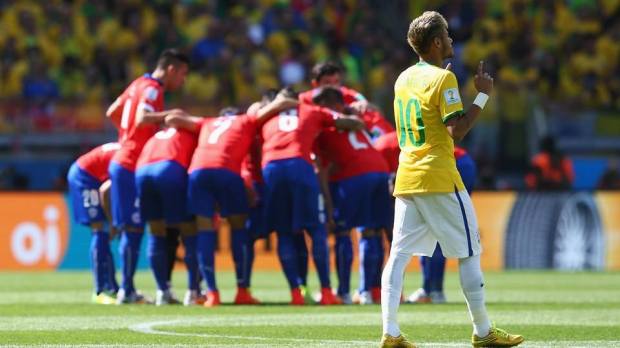 2014 FIFA World Cup - Neymar prays while Chile huddle.