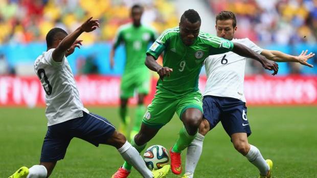 2014 FIFA World Cup - Nigeria's Emmanuel Emenike is challenged by France's Patrice Evra and Yohan Cabaye.