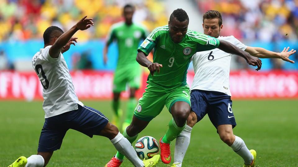 2014 FIFA World Cup - Nigeria's Emmanuel Emenike is challenged by France's Patrice Evra and Yohan Cabaye.