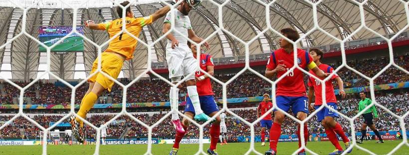 2014 FIFA World Cup - Rafik Halliche (2nd L) of Algeria scores his team's second goal beating Jung Sung-Ryong (1st L) of South Korea