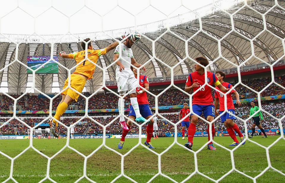 2014 FIFA World Cup - Rafik Halliche (2nd L) of Algeria scores his team's second goal beating Jung Sung-Ryong (1st L) of South Korea