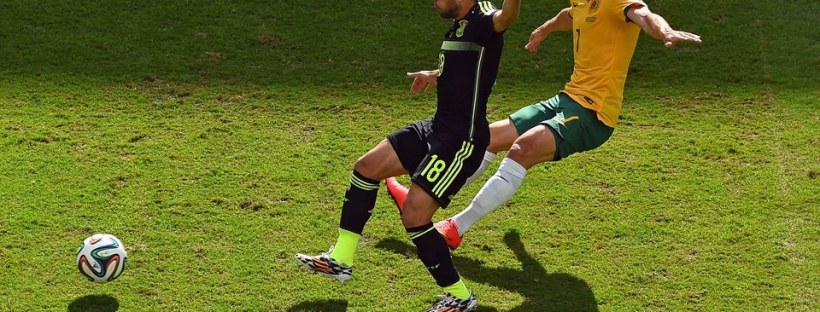 2014 FIFA World Cup - Spain defender Jordi Alba vies for the ball with Australia's Mathew Leckie.