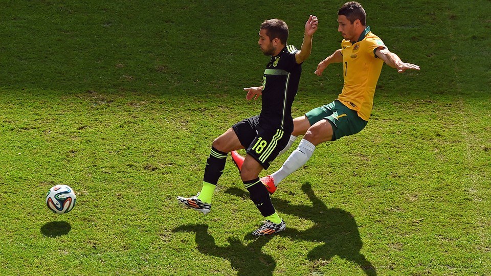 2014 FIFA World Cup - Spain defender Jordi Alba vies for the ball with Australia's Mathew Leckie.