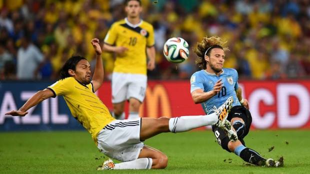 2014 FIFA World Cup - Uruguay's Diego Forlan and Colombia's Abel Aguilar vie for the ball.