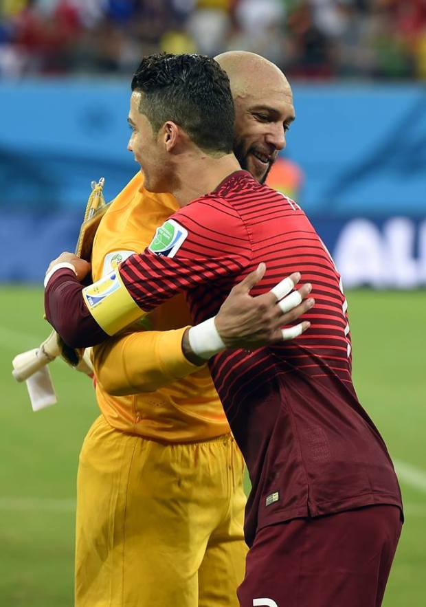 2014 FIFA World Cup - US goalkeeper Tim Howard (L) hugs Portugal's forward Cristiano Ronaldo