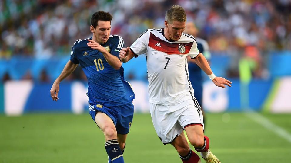 2014 FIFA World Cup - Argentina captain Lionel Messi and Germany midfielder Bastian Schweinsteiger vie for the ball.