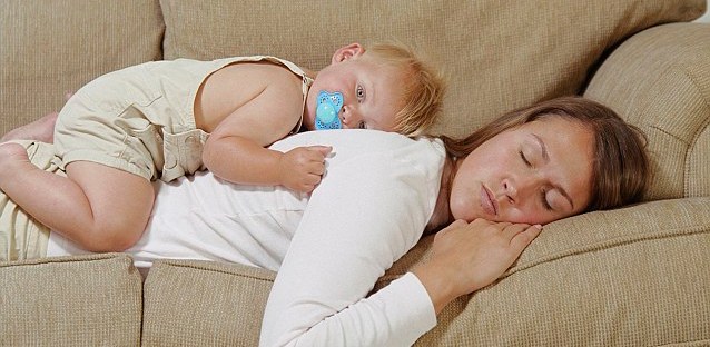 Baby Resting atop Sleeping Mother