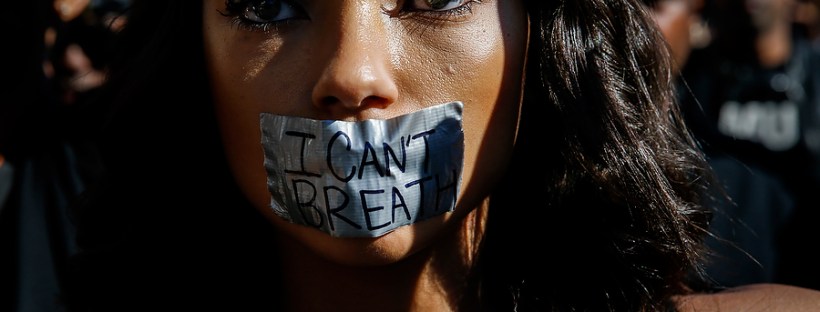 Protester Logan Browning wears tape over her mouth reading "I can't breathe" while demonstrating against the shooting of a man by the Los Angeles Police Department in Hollywood, California