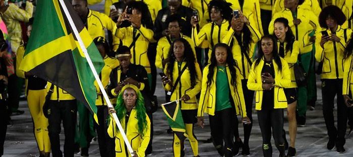 Shelly-Ann Fraser-Pryce carries the flag of Jamaica